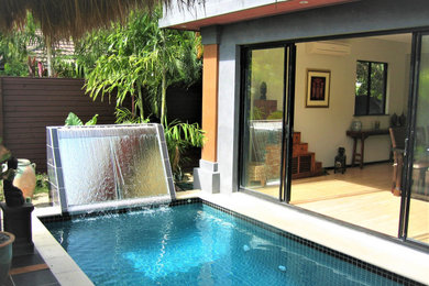 Photo of a tropical backyard l-shaped lap pool in Cairns with with a pool.