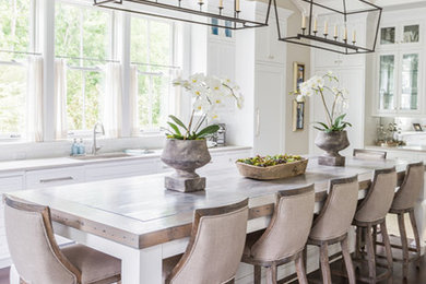 Inspiration for a large timeless u-shaped dark wood floor eat-in kitchen remodel in Nashville with white cabinets, an island, shaker cabinets, an undermount sink, quartz countertops, white backsplash, subway tile backsplash and stainless steel appliances