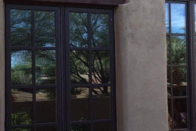 Example of a mid-sized southwest beige two-story exterior home design in Phoenix