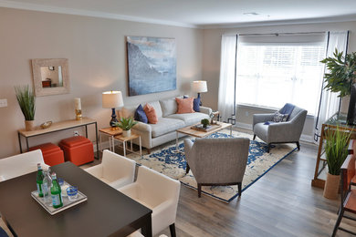 Small eclectic open concept living room in Bridgeport with grey walls and light hardwood floors.
