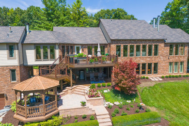 Deck - large contemporary backyard second story metal railing deck idea in Other with a bbq area and a pergola