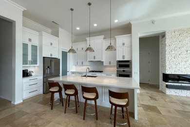 Mid-sized transitional l-shaped porcelain tile and beige floor open concept kitchen photo in Phoenix with a single-bowl sink, raised-panel cabinets, quartz countertops, stainless steel appliances, an island and white countertops