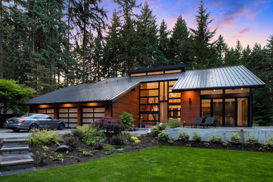 Inspiration for a contemporary multicolored three-story wood house exterior remodel in Seattle with a shed roof and a metal roof