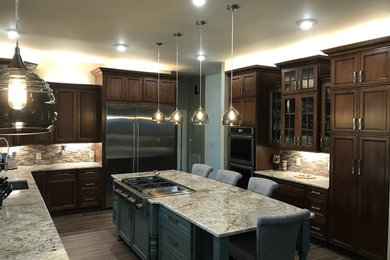 Enclosed kitchen - large traditional u-shaped dark wood floor and brown floor enclosed kitchen idea in Raleigh with an undermount sink, recessed-panel cabinets, dark wood cabinets, granite countertops, multicolored backsplash, matchstick tile backsplash, stainless steel appliances, an island and gray countertops