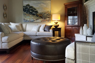 Mid-sized transitional open concept medium tone wood floor and brown floor living room photo in Other with beige walls, a standard fireplace and a brick fireplace
