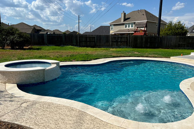 Island style pool photo in Houston