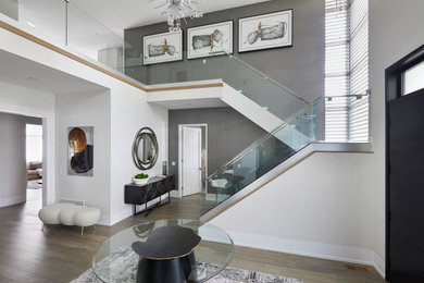 Стильный дизайн: п-образная лестница в современном стиле с деревянными ступенями, стеклянными перилами и обоями на стенах без подступенок - последний тренд