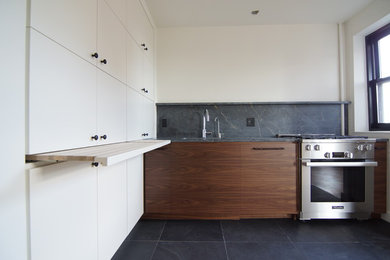 Example of a small trendy l-shaped ceramic tile open concept kitchen design in New York with a single-bowl sink, flat-panel cabinets, white cabinets, limestone countertops, gray backsplash, stone slab backsplash, stainless steel appliances and no island