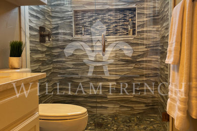 Inspiration for a mid-sized 1960s multicolored tile and porcelain tile porcelain tile, beige floor and single-sink alcove shower remodel in Dallas with raised-panel cabinets, white cabinets, a two-piece toilet, beige walls, an undermount sink, quartz countertops, a hinged shower door, beige countertops, a niche and a built-in vanity