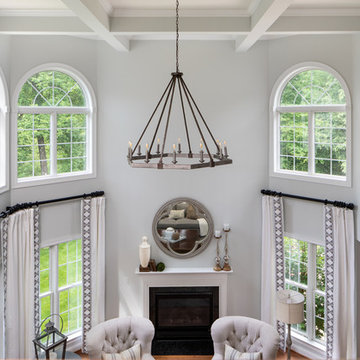 Neutral Two Story Family Room with Tufted Wing Chairs