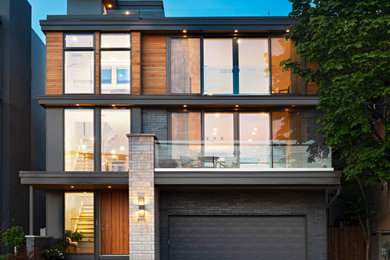 Contemporary black three-story wood and clapboard flat roof idea in Ottawa