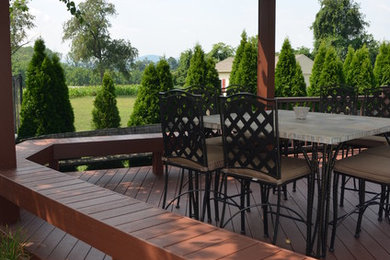 This is an example of a mid-sized traditional backyard deck in Philadelphia.