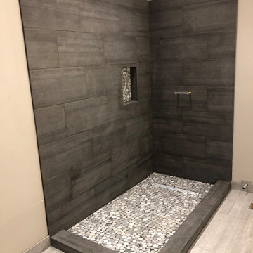 Shower remodel with pebble tile niche and floor
