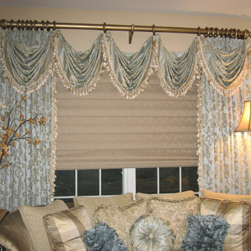 Stationary Drapery Panels with Swag Overlays on Decorative Wood Poles