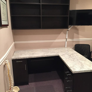 Medium sized modern study in New York with yellow walls, carpet, no fireplace, a freestanding desk and blue floors.