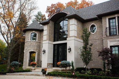 Inspiration for a huge timeless brown two-story brick exterior home remodel in Detroit