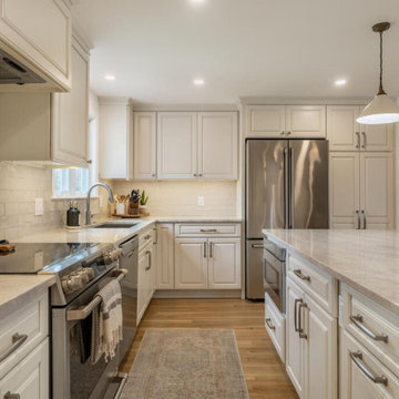 White kitchen with a Cafe range and Taj Mahal quartzite counters