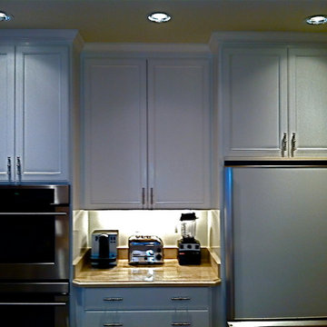 COUNTER IN MIDDLE CREATES SPACE FOR BOTH FRIG AND OVENS
