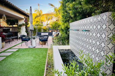 Mid-sized mediterranean white two-story stucco house exterior idea in San Diego with a brown roof