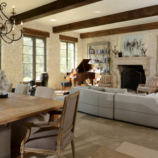 Foto de salón con rincón musical abierto, mediterráneo, con paredes beige, chimenea tradicional, marco de chimenea de piedra y televisor independiente