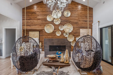 Inspiration for a mid-sized eclectic formal and open concept medium tone wood floor and brown floor living room remodel in Dallas with gray walls, a standard fireplace, a tile fireplace and no tv