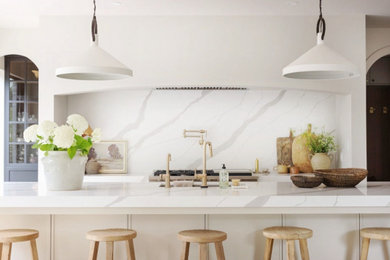Inspiration for a large scandinavian single-wall light wood floor and brown floor eat-in kitchen remodel in Other with an undermount sink, recessed-panel cabinets, beige cabinets, quartz countertops, white backsplash, quartz backsplash, stainless steel appliances, an island and white countertops