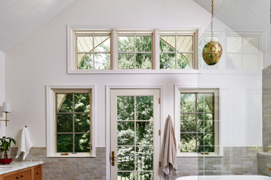 Large transitional master gray tile and ceramic tile cement tile floor, gray floor and double-sink bathroom photo in DC Metro with furniture-like cabinets, brown cabinets, white walls, a drop-in sink, marble countertops, white countertops and a built-in vanity