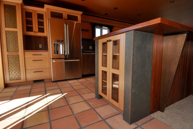 Eat-in kitchen - mid-sized coastal u-shaped terra-cotta tile and red floor eat-in kitchen idea in San Luis Obispo with an undermount sink, shaker cabinets, light wood cabinets, concrete countertops, metallic backsplash, porcelain backsplash, stainless steel appliances and a peninsula