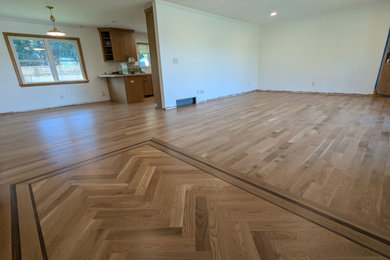 Example of a light wood floor entryway design in Milwaukee