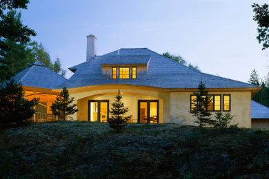 Mid-sized traditional two-story stucco exterior home idea in Other