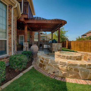 Outdoor Living Complete with Kitchen, Firepit, and Balcony