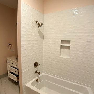 Elegant Guest Bath: Soft Terracotta Walls, Marble Vanity, and Modern Black Fixtu