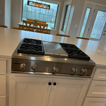 Gas Cooktop with White Base Cabinetry and Large Window View