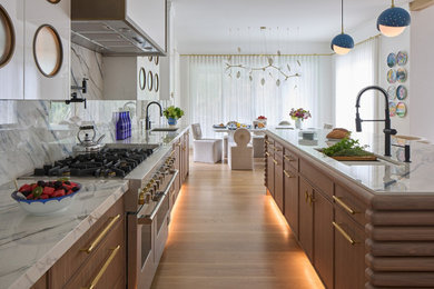 Example of a mid-sized trendy kitchen design in New York with an island