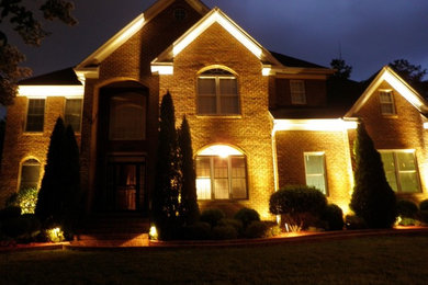 Two-story brick exterior home idea in Other