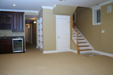 Photo of a large fully buried basement in New York with beige walls and carpet.