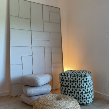 Padded Wall Panel and Round Poufs in Lisbon Living Room