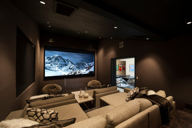 Large trendy enclosed brown floor home theater photo in Austin with brown walls and a projector screen