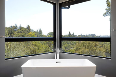 Inspiration for a large contemporary master white tile and porcelain tile porcelain tile, gray floor and double-sink bathroom remodel in San Francisco with flat-panel cabinets, light wood cabinets, a one-piece toilet, gray walls, an undermount sink, marble countertops, a hinged shower door, white countertops and a floating vanity