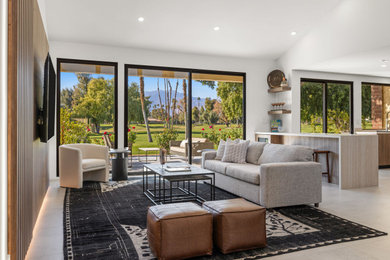 Living room - modern open concept concrete floor, gray floor and wood wall living room idea in Other with white walls and a wall-mounted tv