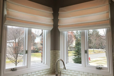 Mid-sized transitional l-shaped open concept kitchen photo in Detroit with raised-panel cabinets, white cabinets, quartz countertops, white backsplash, glass tile backsplash and white countertops