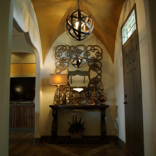 Design ideas for an eclectic foyer in Austin with beige walls, vinyl floors and a green front door.