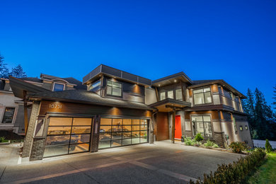 Large minimalist gray three-story house exterior photo in Vancouver with a hip roof, a shingle roof and a black roof