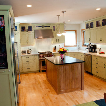 Green inset cabinet with cherry island.