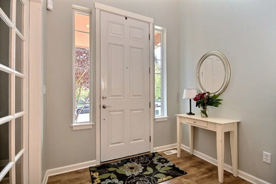Small transitional light wood floor front door photo in Seattle with gray walls
