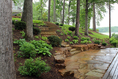 Design ideas for a mid-sized coastal partial sun hillside stone retaining wall landscape in DC Metro for spring.