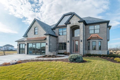 Large transitional gray two-story stone house exterior idea in Chicago