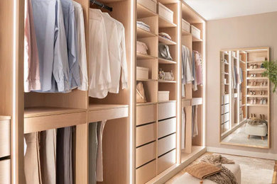 Walk-in closet - mid-sized coastal gender-neutral light wood floor and beige floor walk-in closet idea in Los Angeles with flat-panel cabinets and light wood cabinets