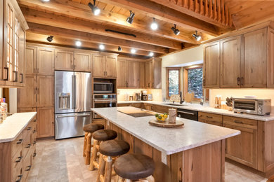 Large mountain style u-shaped vaulted ceiling open concept kitchen photo in Denver with an undermount sink, shaker cabinets, medium tone wood cabinets, stainless steel appliances and an island