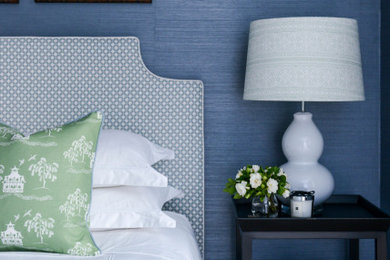 Inspiration for a mid-sized traditional guest bedroom in Sydney with blue walls, carpet, beige floor and wallpaper.